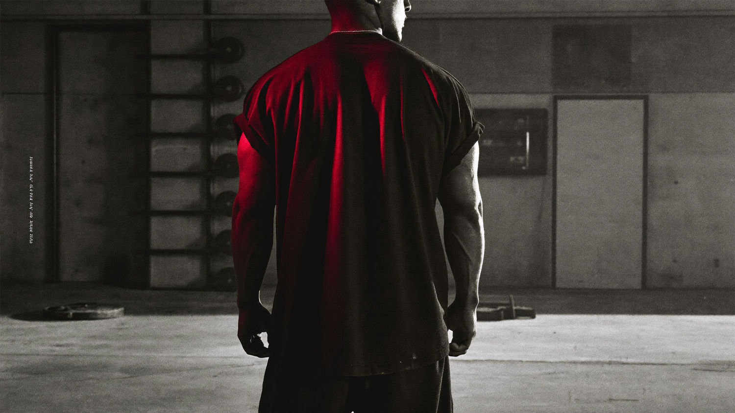 Athlete in an oversized heavyweight black SUBLEVEL t-shirt in a dim industrial gym